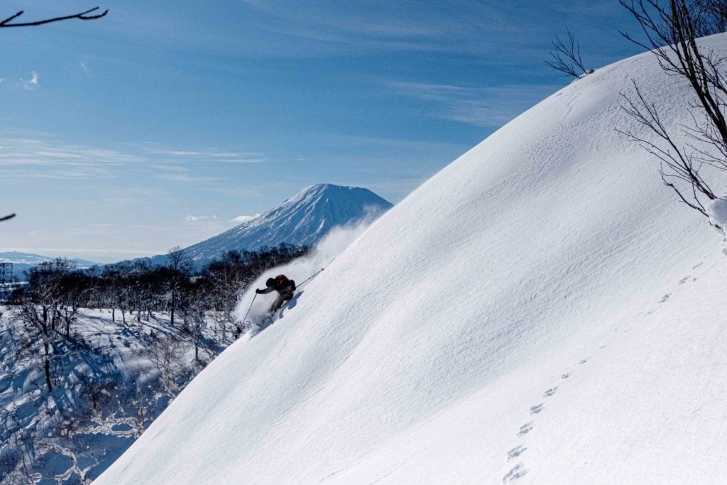 skier enjoying well deserved turns in the niseko backcountry